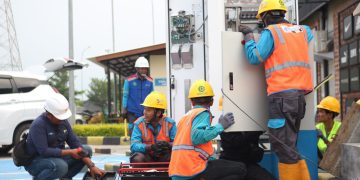 Petugas PLN tengah melakukan instalasi dan integrasi sistem pada SPKLU di rest area 389 B, Kendal, Jawa Tengah.